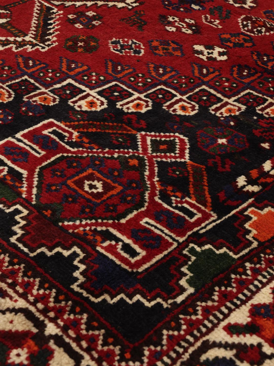 Hand-knotted Shiraz rug from the Middle East in dark red and dark blue