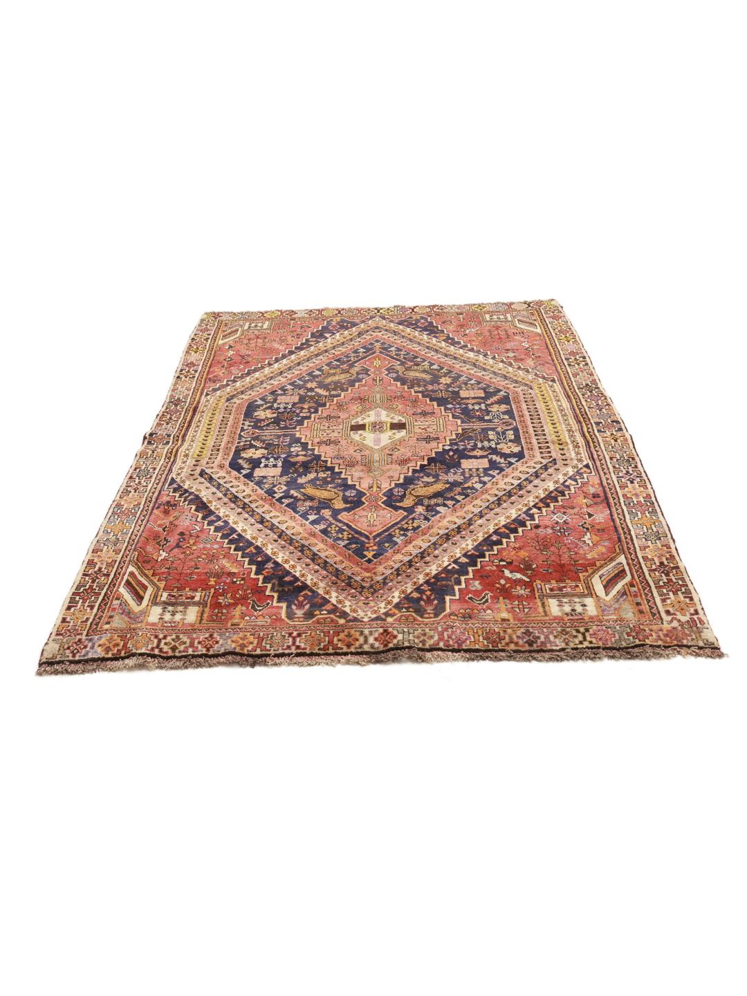 A unique, hand-knotted Qashqai rug from the Middle East featuring a bold multicolor diamond medallion.