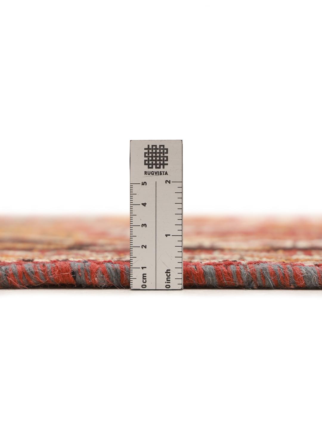 Hand-knotted Ghashghai rug from the Middle East featuring a red and black tribal pattern.