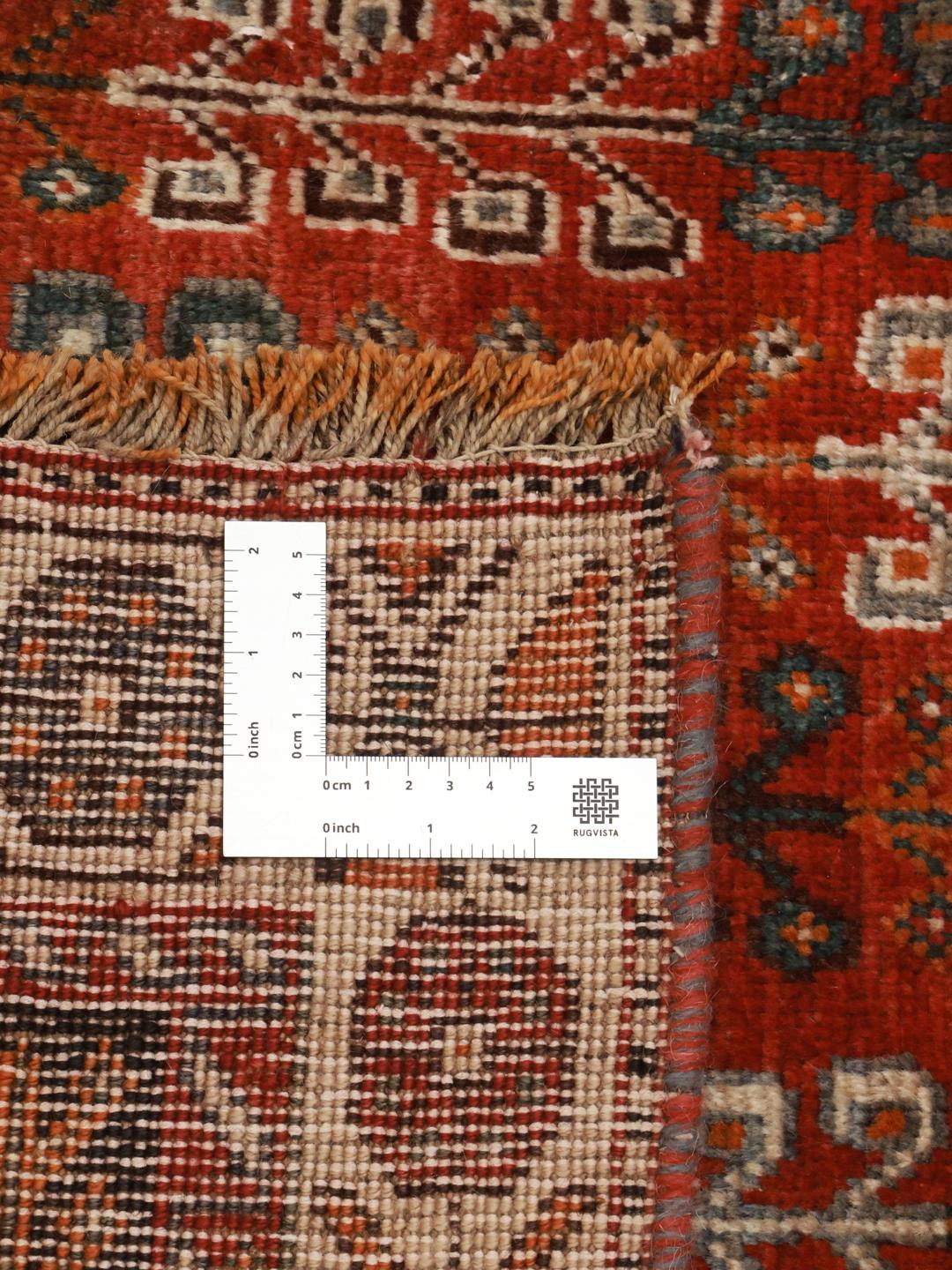 Hand-knotted Ghashghai rug from the Middle East featuring a red and black tribal pattern.
