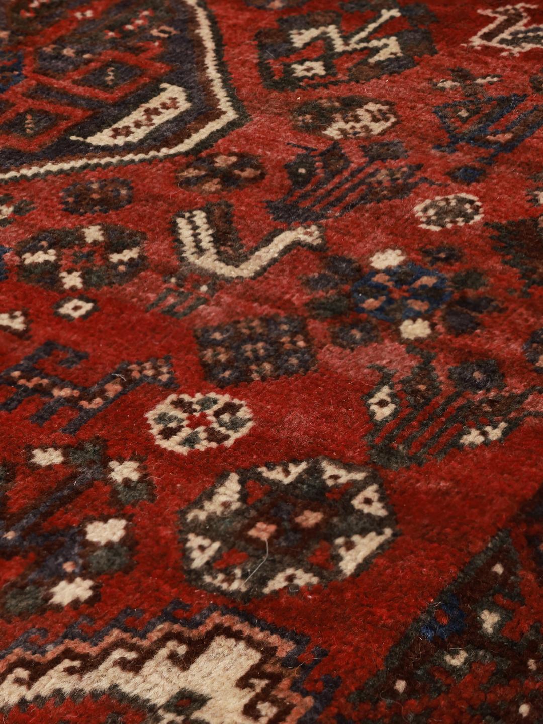 Hand-knotted Shiraz rug from the Middle East in deep red tones