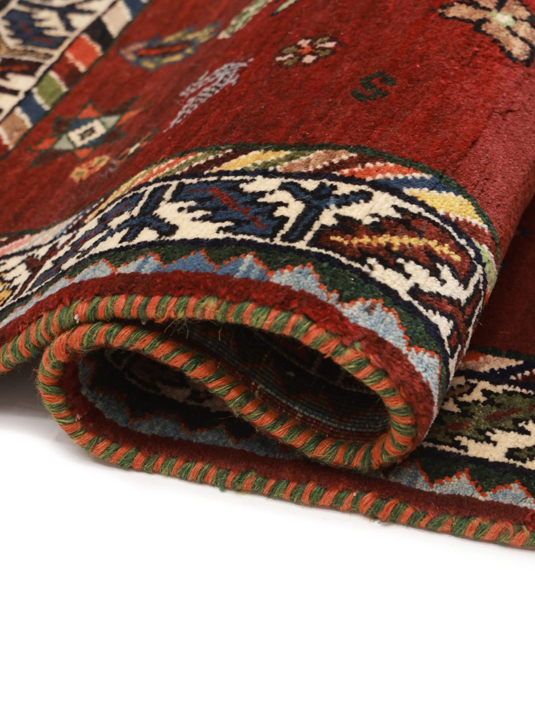 Hand-knotted Ghashghai rug from the Middle East featuring a red and dark blue colour palette