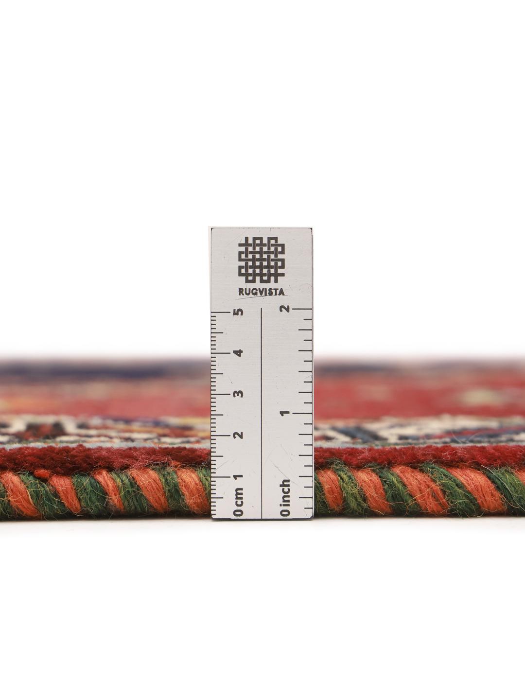 Hand-knotted Ghashghai rug from the Middle East featuring a red and dark blue colour palette