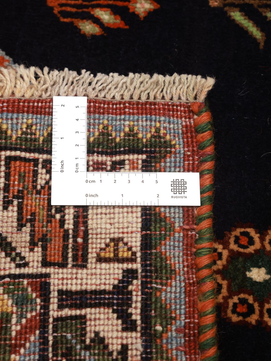 Hand-knotted Ghashghai rug from the Middle East featuring a red and dark blue colour palette