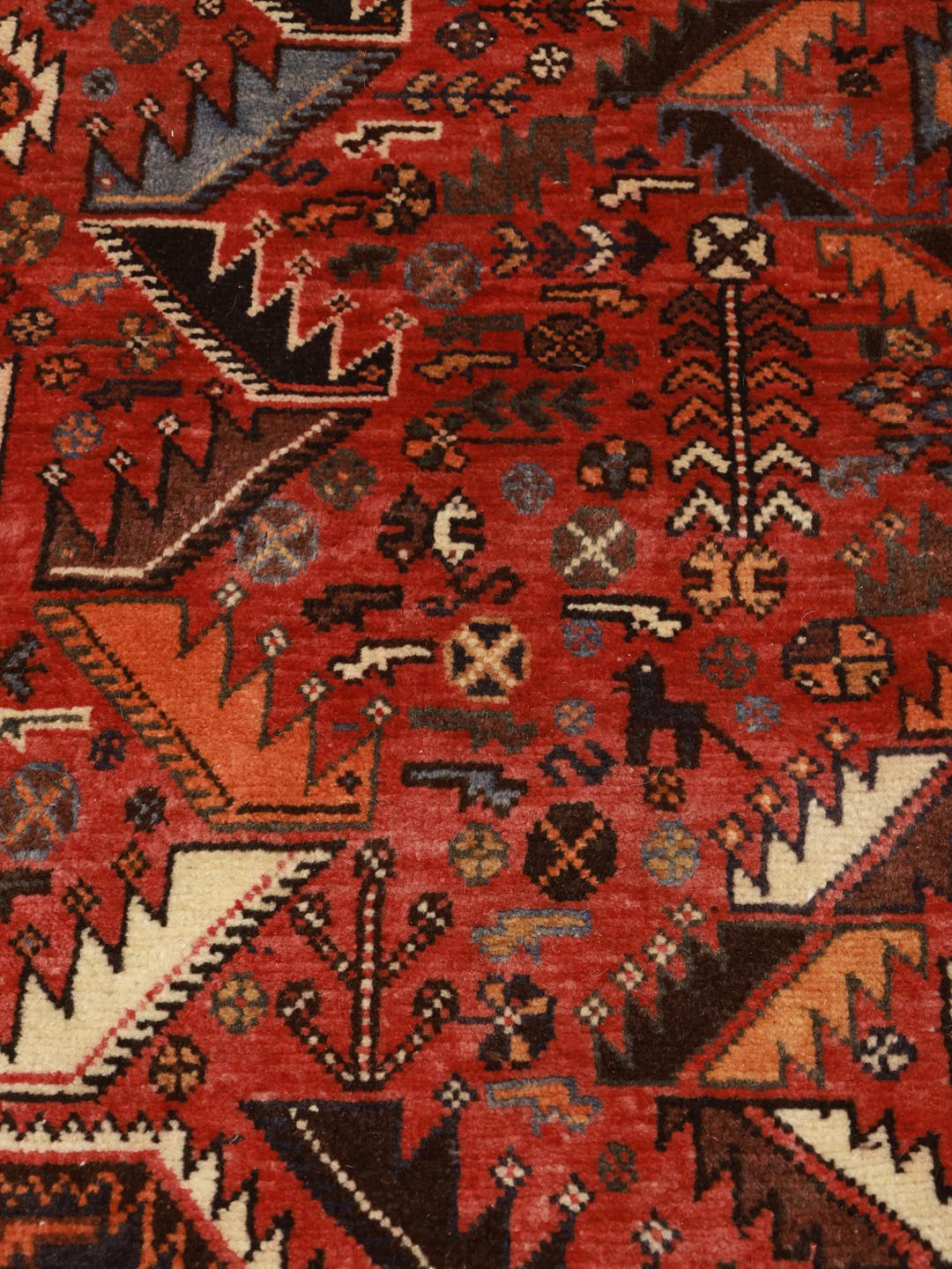 Hand-knotted Ghashghai rug with red and blue tribal geometric patterns from the Middle East