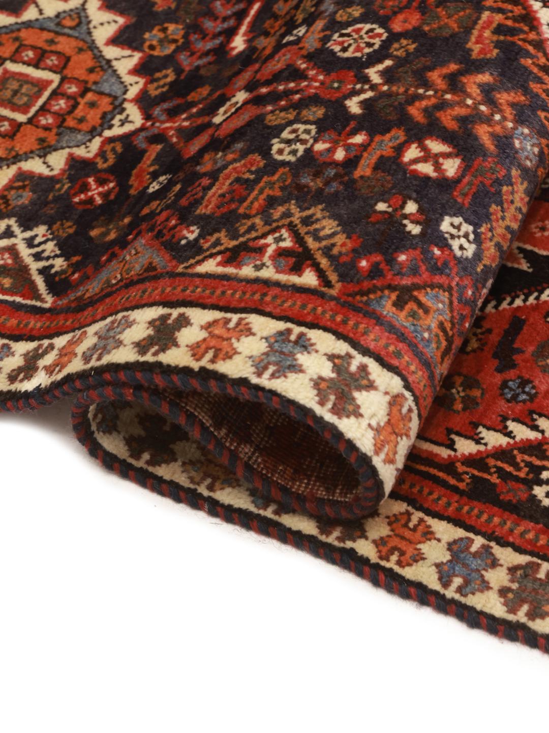 Hand-knotted Ghashghai rug with red and blue tribal geometric patterns from the Middle East