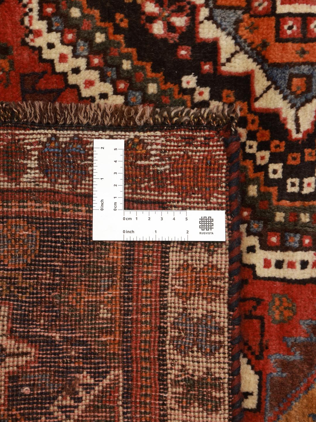 Hand-knotted Ghashghai rug with red and blue tribal geometric patterns from the Middle East