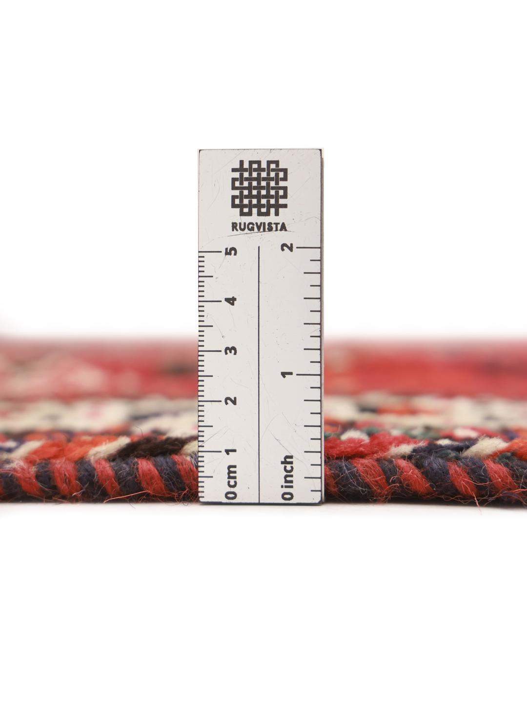 A hand-knotted Shiraz rug from the Middle East in deep red with geometric patterns.