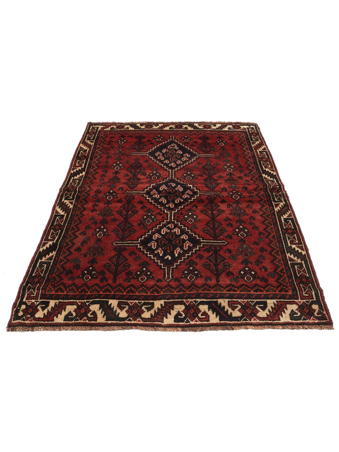 A hand-knotted Shiraz rug from the Middle East featuring geometric patterns in dark red and deep blue