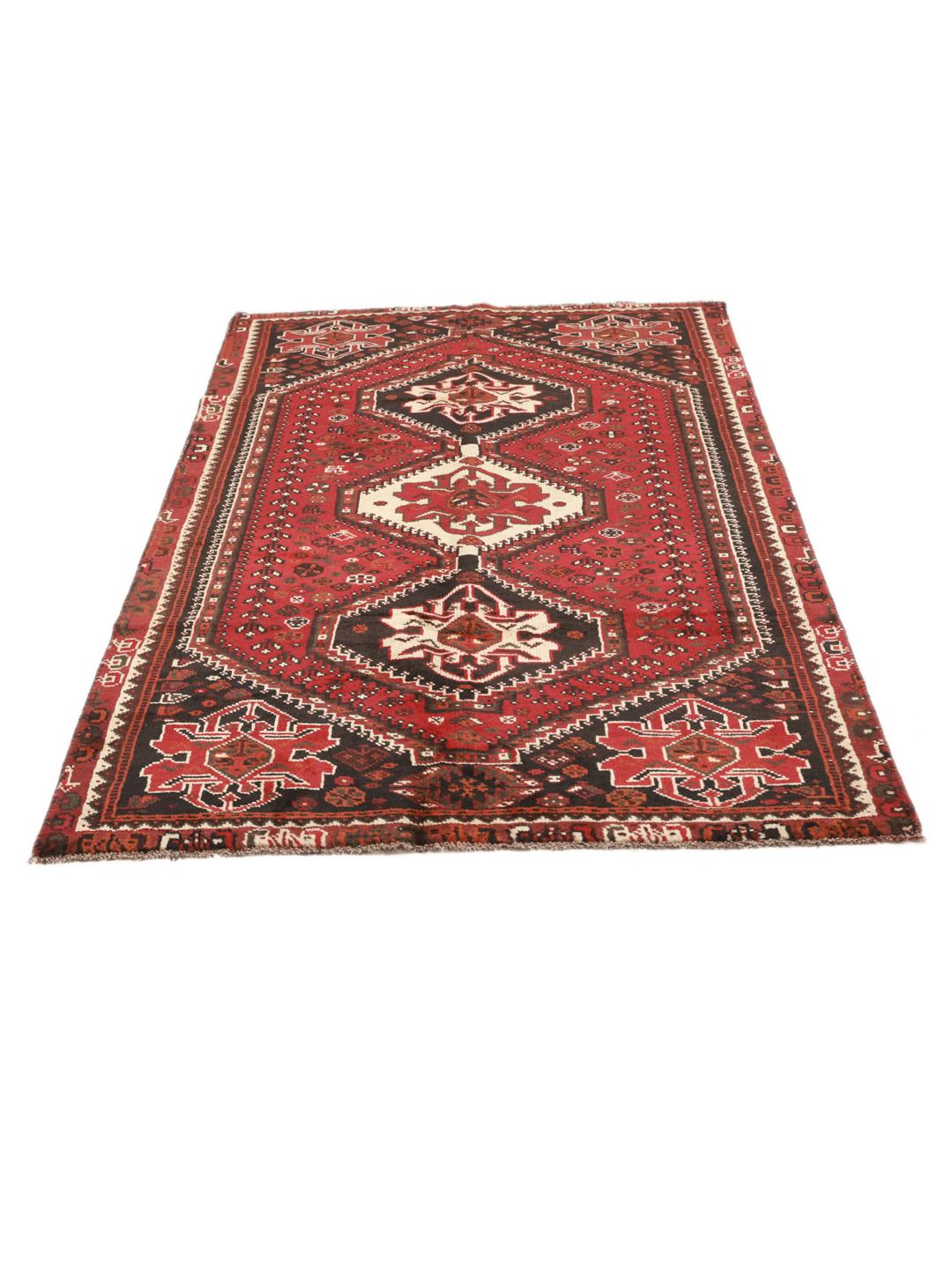 Authentic hand-knotted Ghashghai rug with red and black wool geometric patterns from the Middle East.