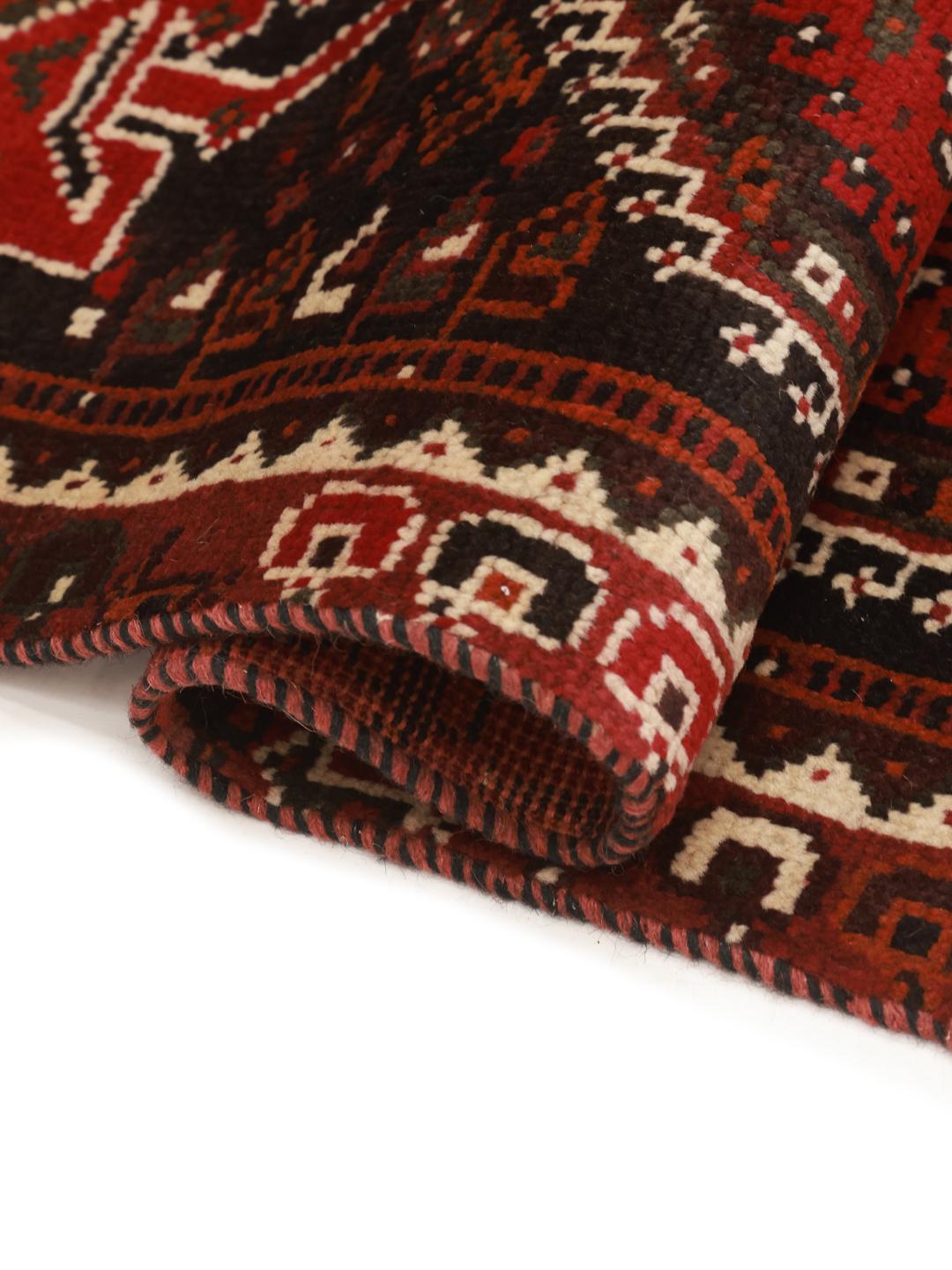 Authentic hand-knotted Ghashghai rug with red and black wool geometric patterns from the Middle East.