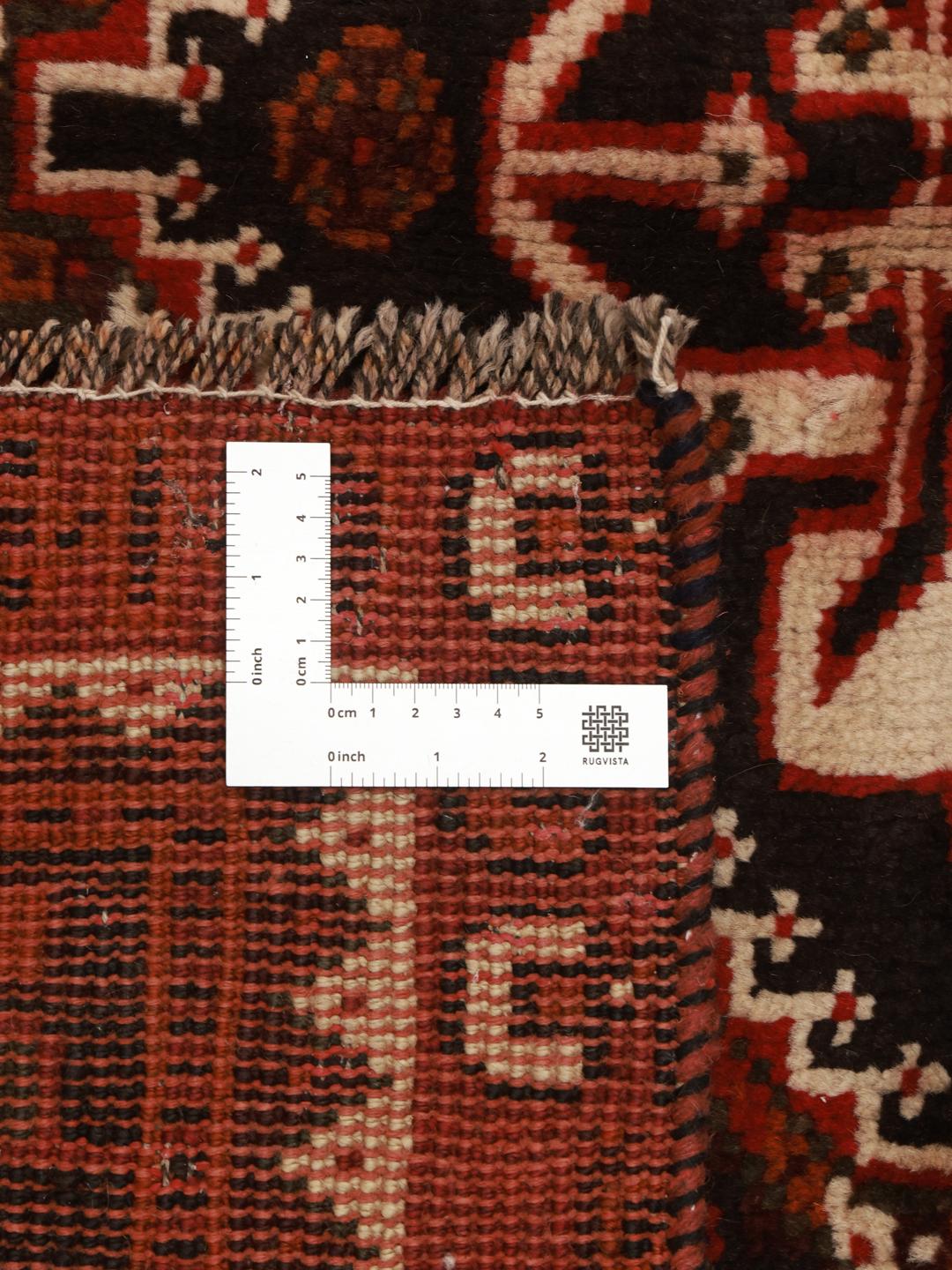 Authentic hand-knotted Ghashghai rug with red and black wool geometric patterns from the Middle East.