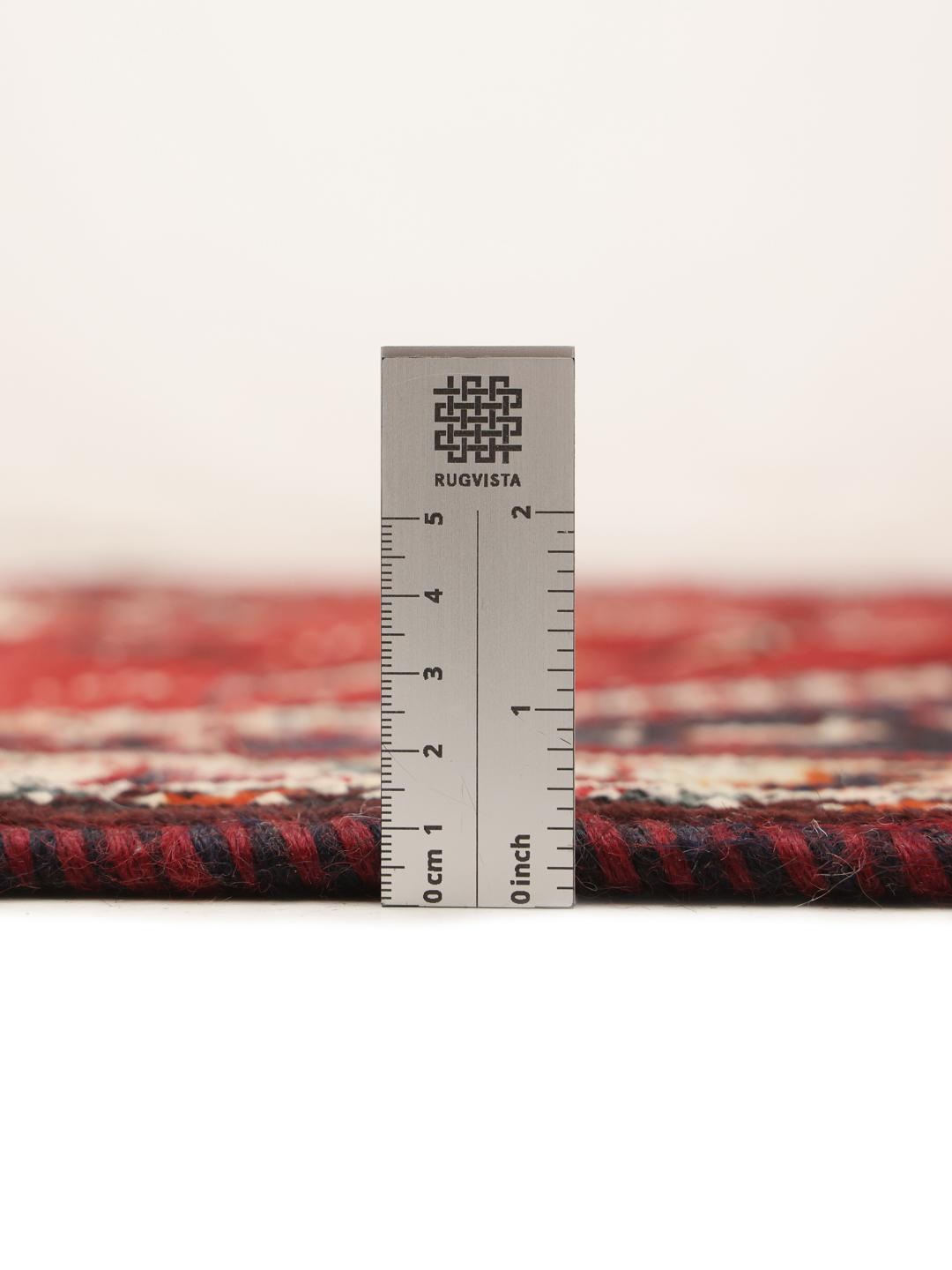 Hand-knotted Middle Eastern rug with red and black geometric patterns