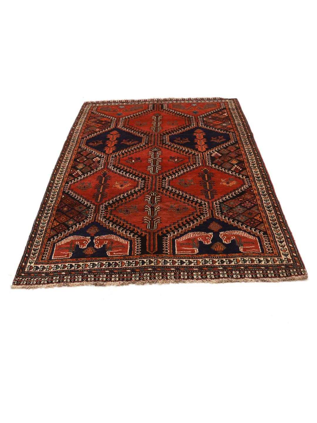 A hand-knotted Qashqai rug from the Middle East featuring a vibrant red and blue geometric pattern.