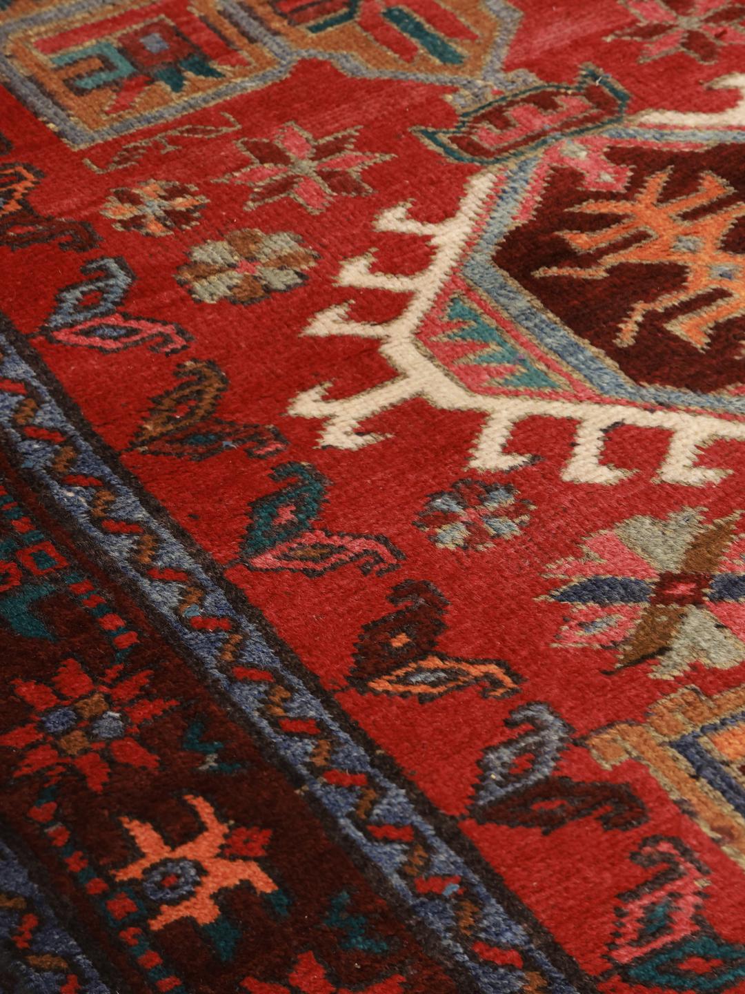 Hand-knotted Middle Eastern runner in red with geometric medallions