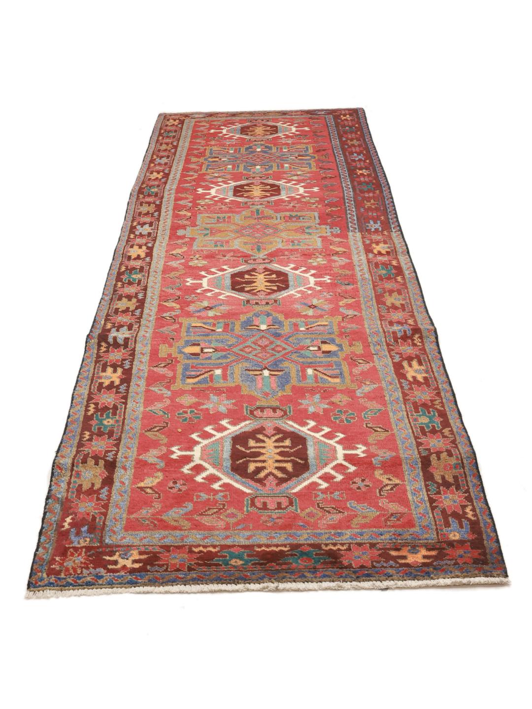 Hand-knotted Middle Eastern runner in red with geometric medallions