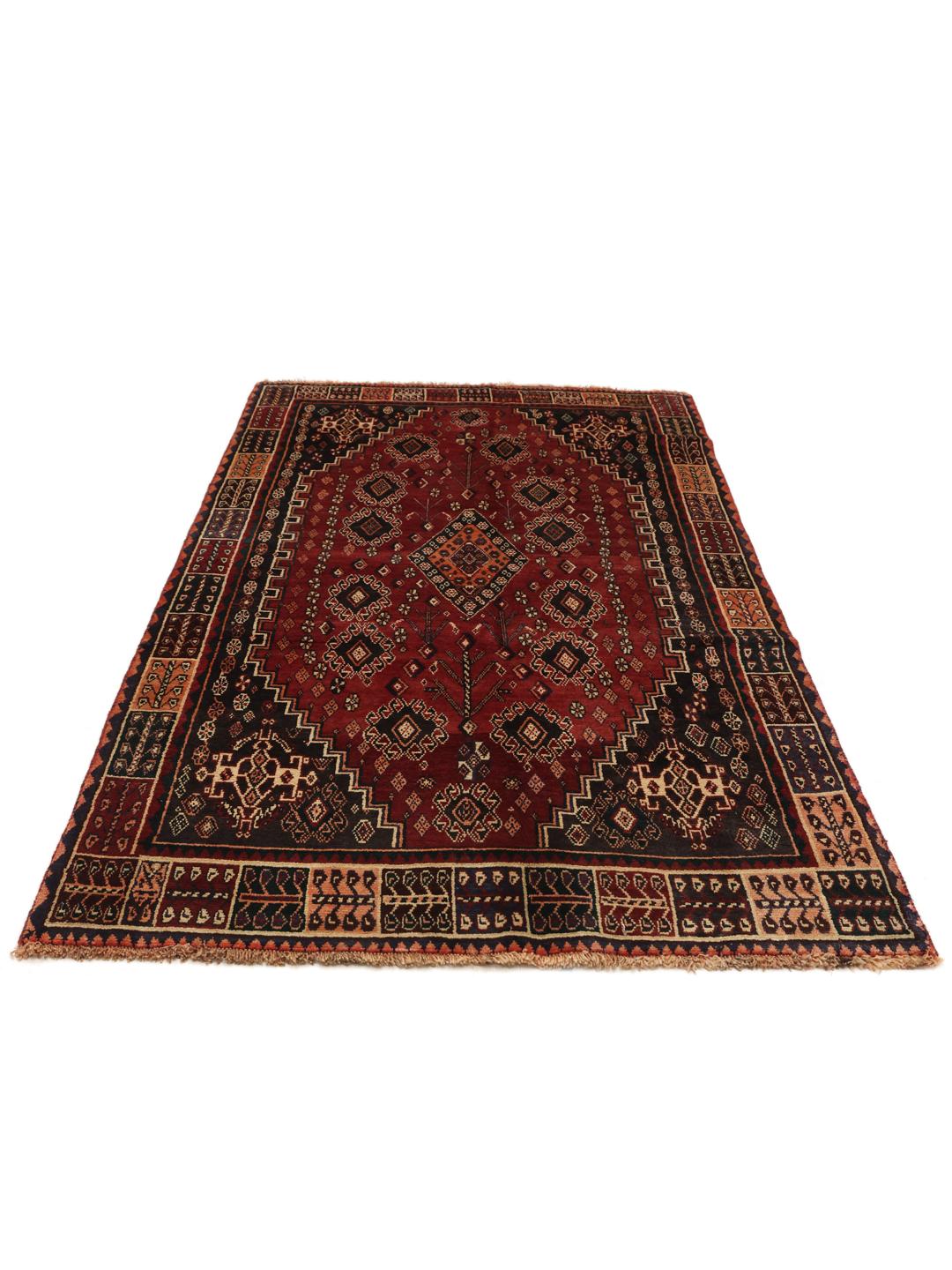 Hand-knotted Ghashghai rug from the Middle East in deep red and black tones