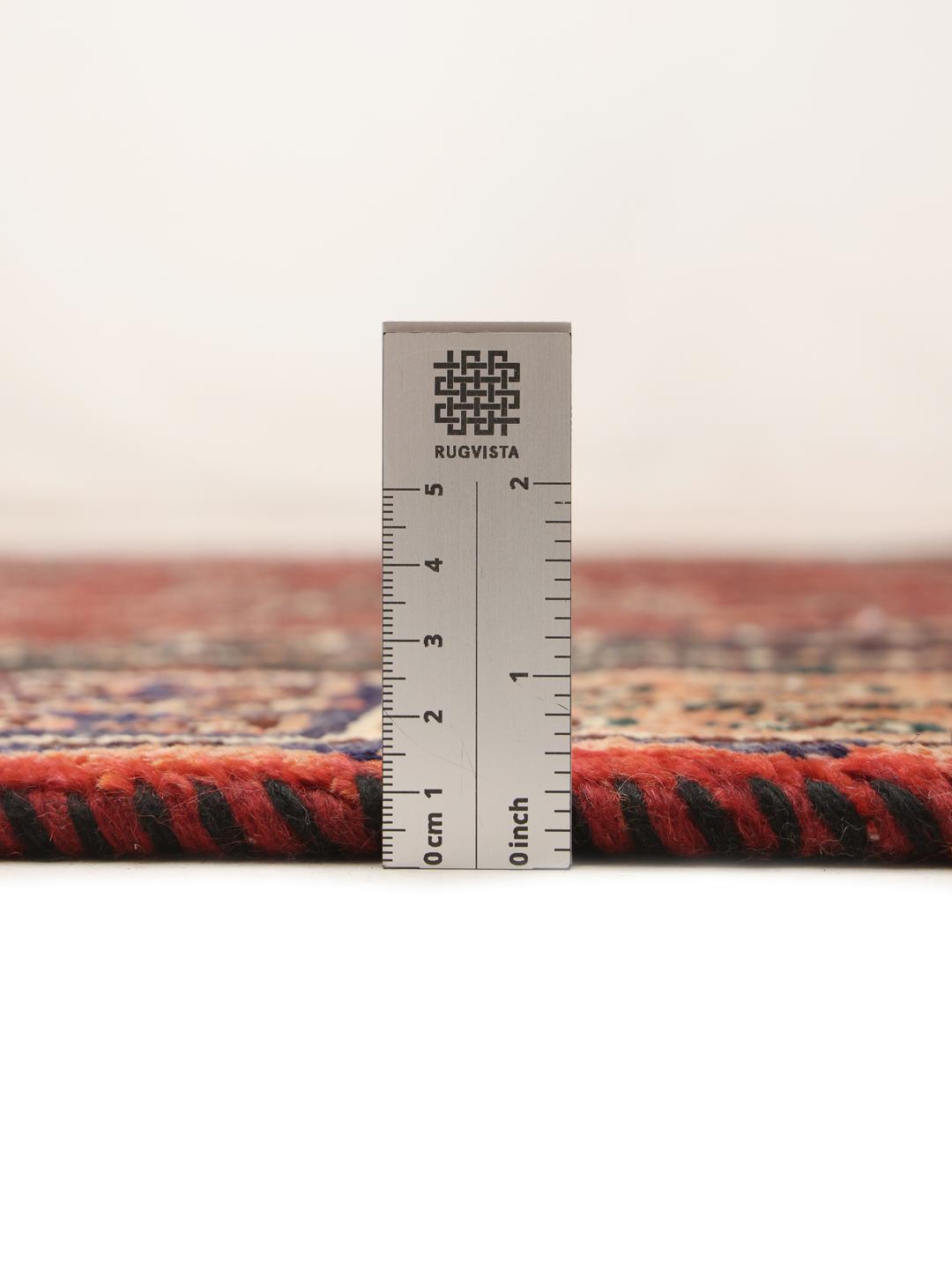 Hand-knotted Ghashghai rug from the Middle East in deep red and black tones