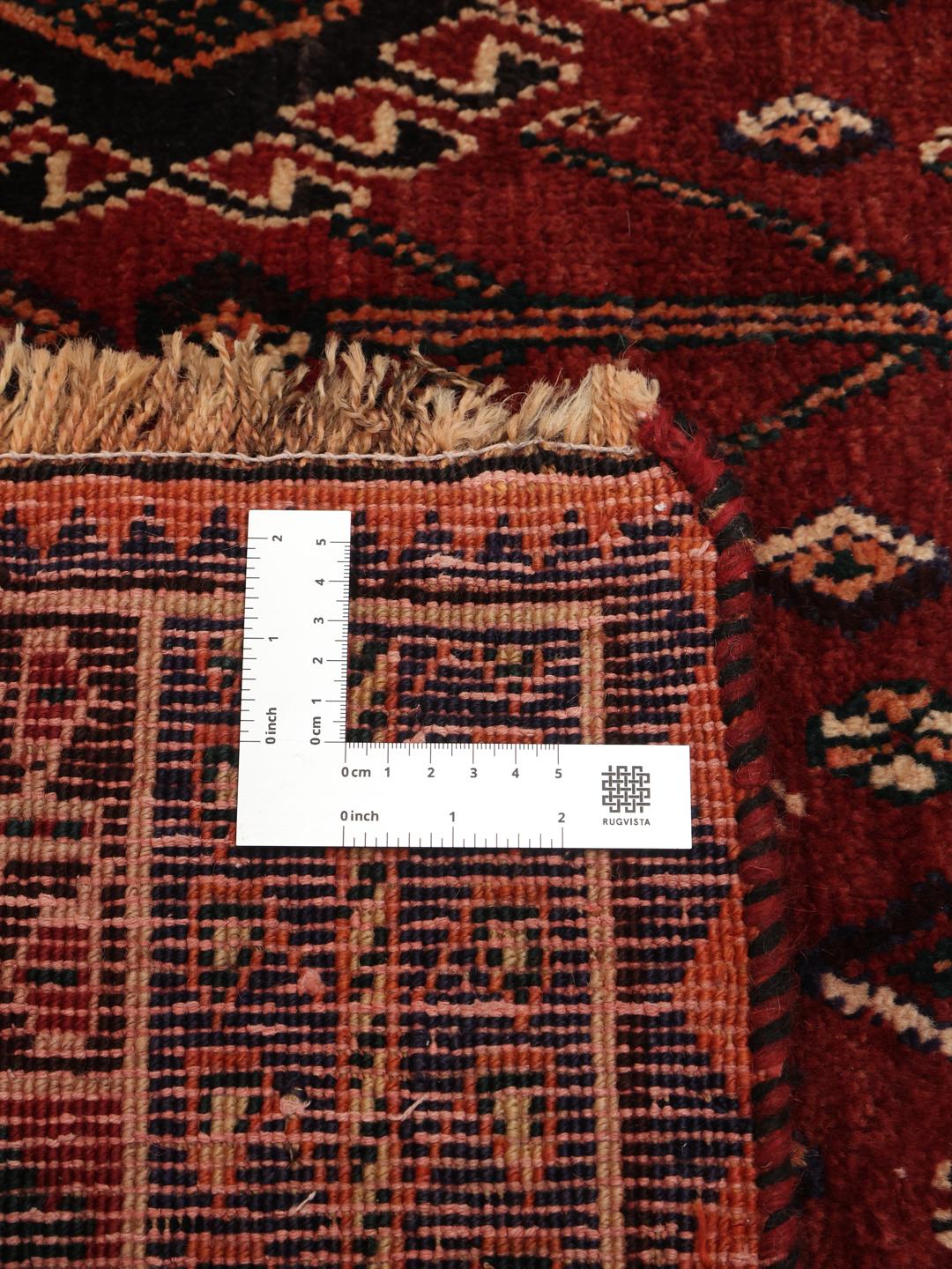 Hand-knotted Ghashghai rug from the Middle East in deep red and black tones