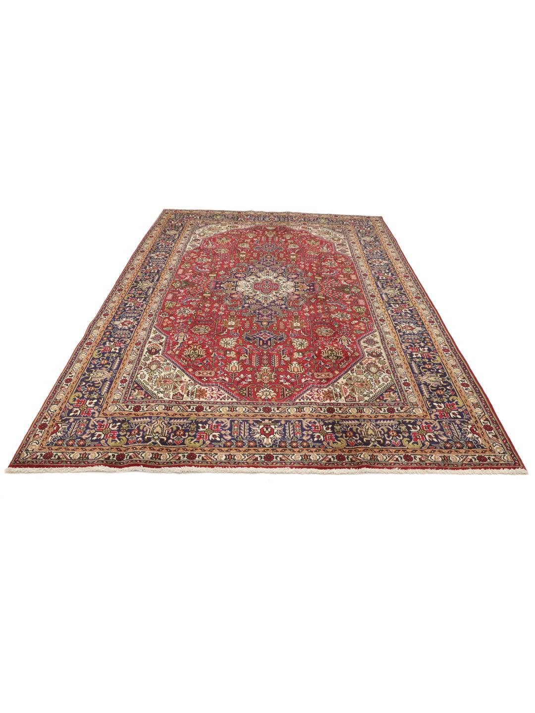 Handmade Tabriz rug from the Middle East featuring a red and blue floral medallion pattern