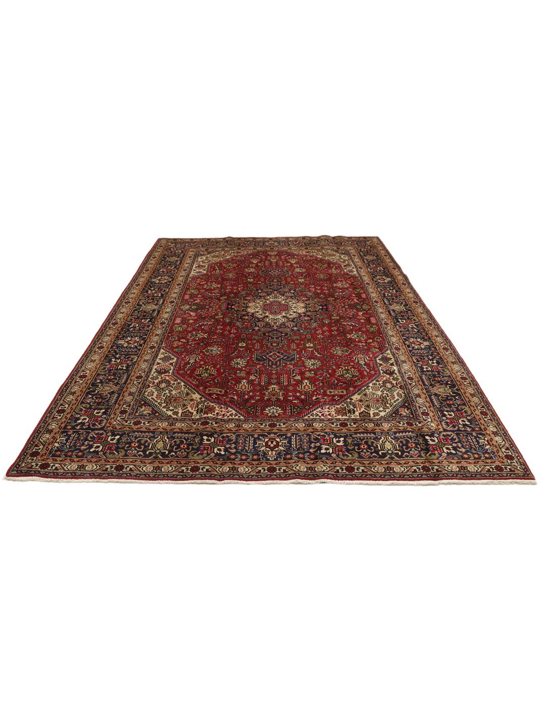 Handmade Tabriz rug from the Middle East featuring a red and blue floral medallion pattern