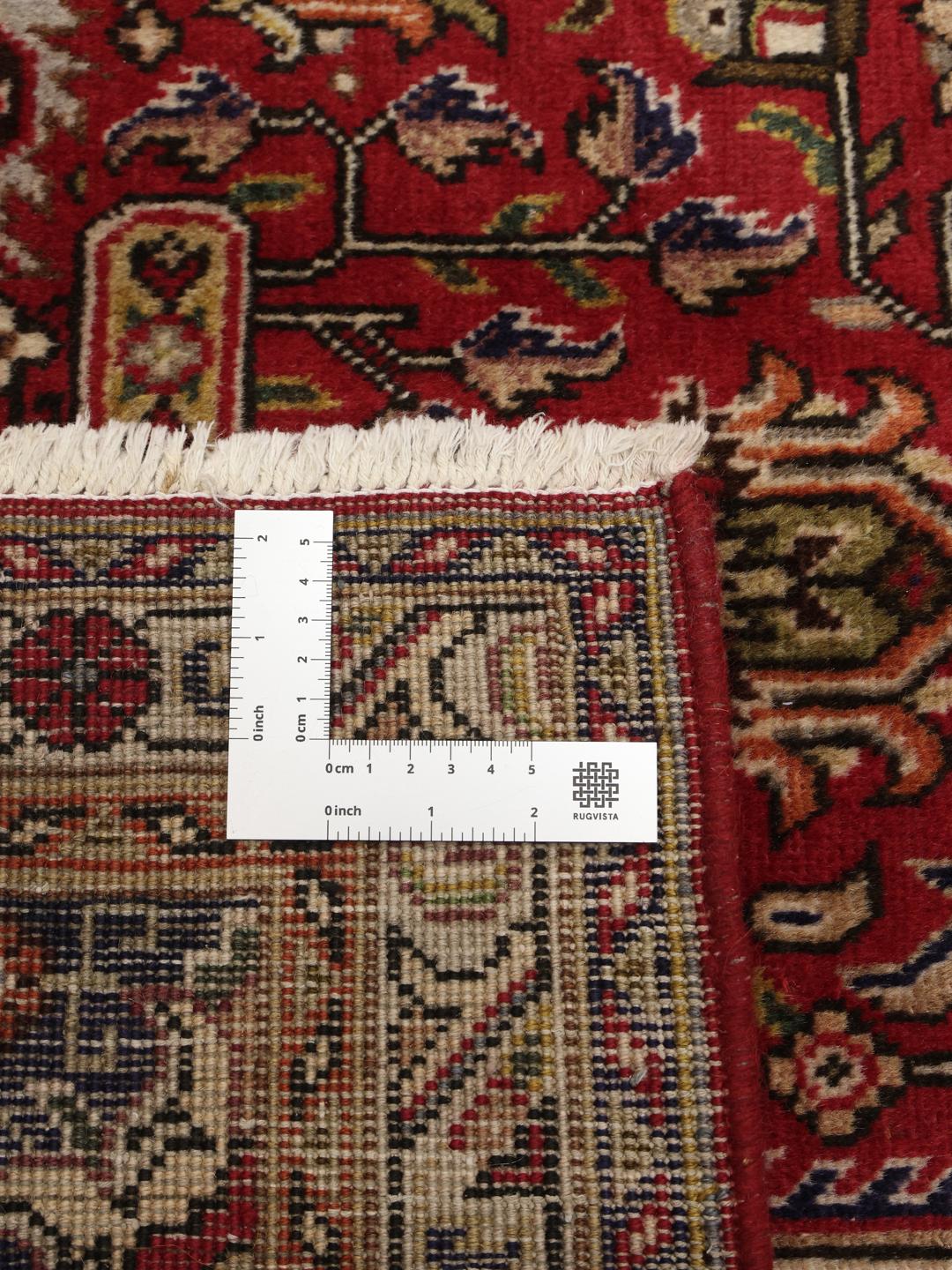 Handmade Tabriz rug from the Middle East featuring a red and blue floral medallion pattern
