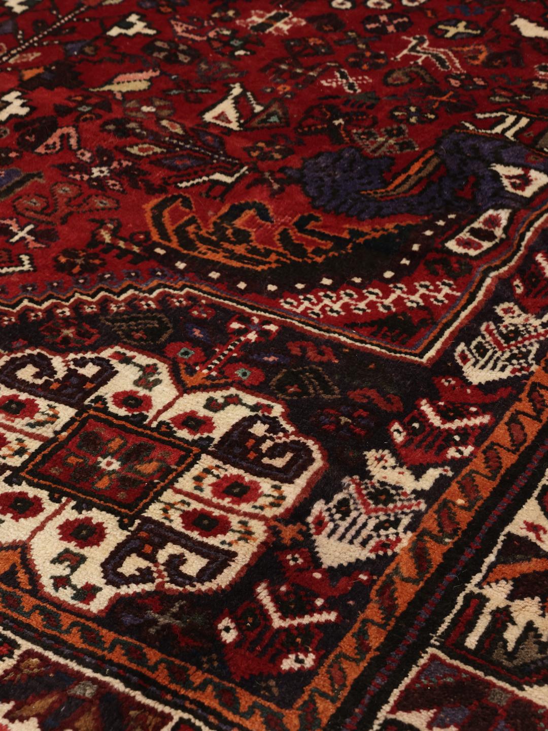 Hand-knotted Ghashghai Wool rug with geometric patterns in red and dark blue