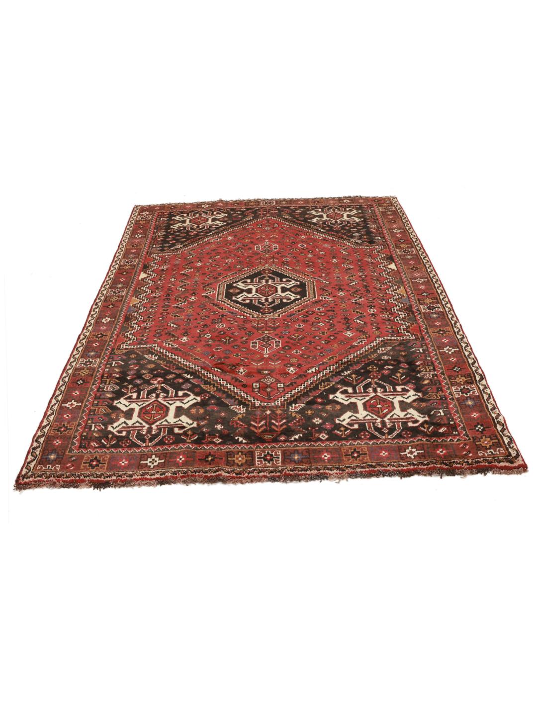 Hand-knotted Ghashghai rug from the Middle East featuring a vibrant red and black palette