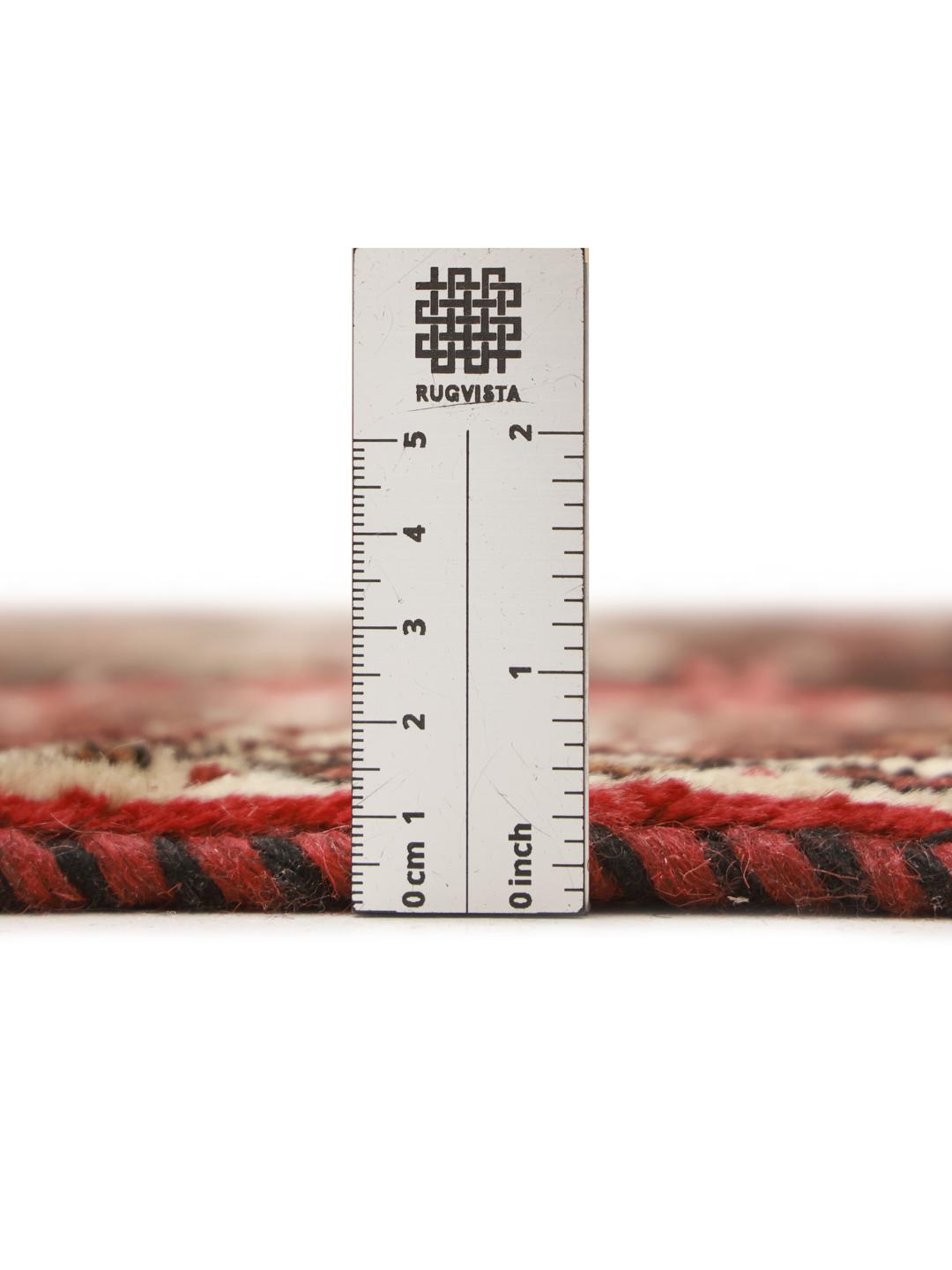 Hand-knotted Ghashghai rug from the Middle East featuring a vibrant red and black palette