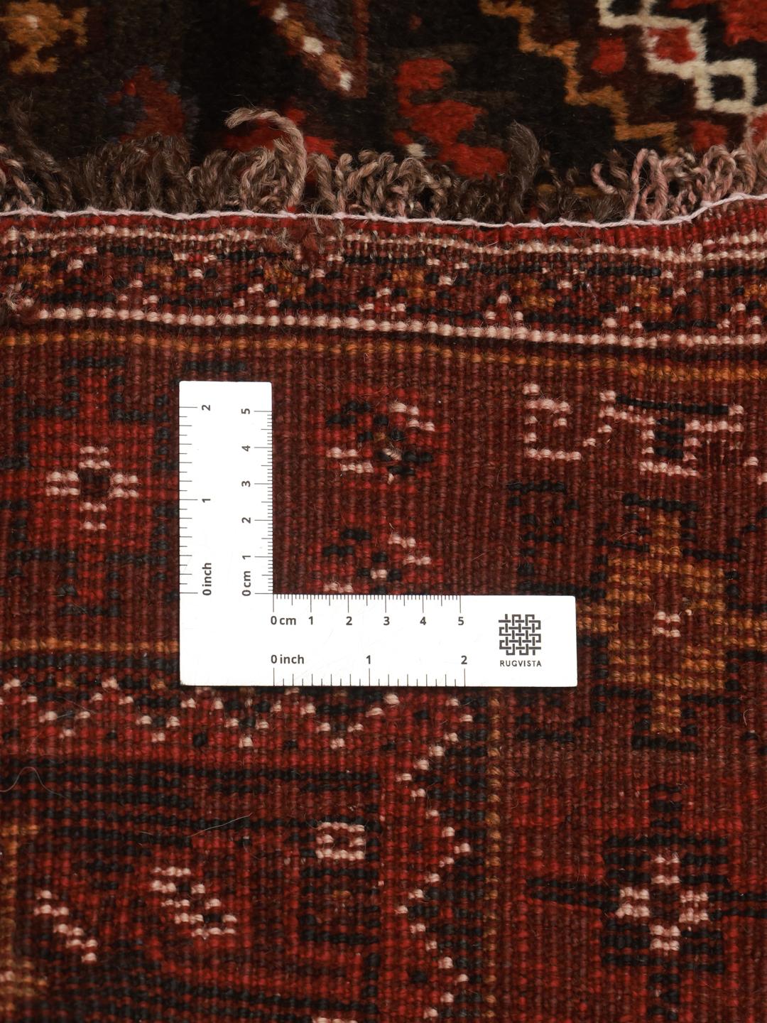Hand-knotted Ghashghai rug from the Middle East featuring a vibrant red and black palette