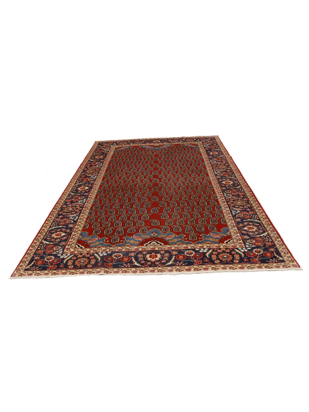 A hand-knotted Tabriz rug from the Middle East with a red field and boteh pattern