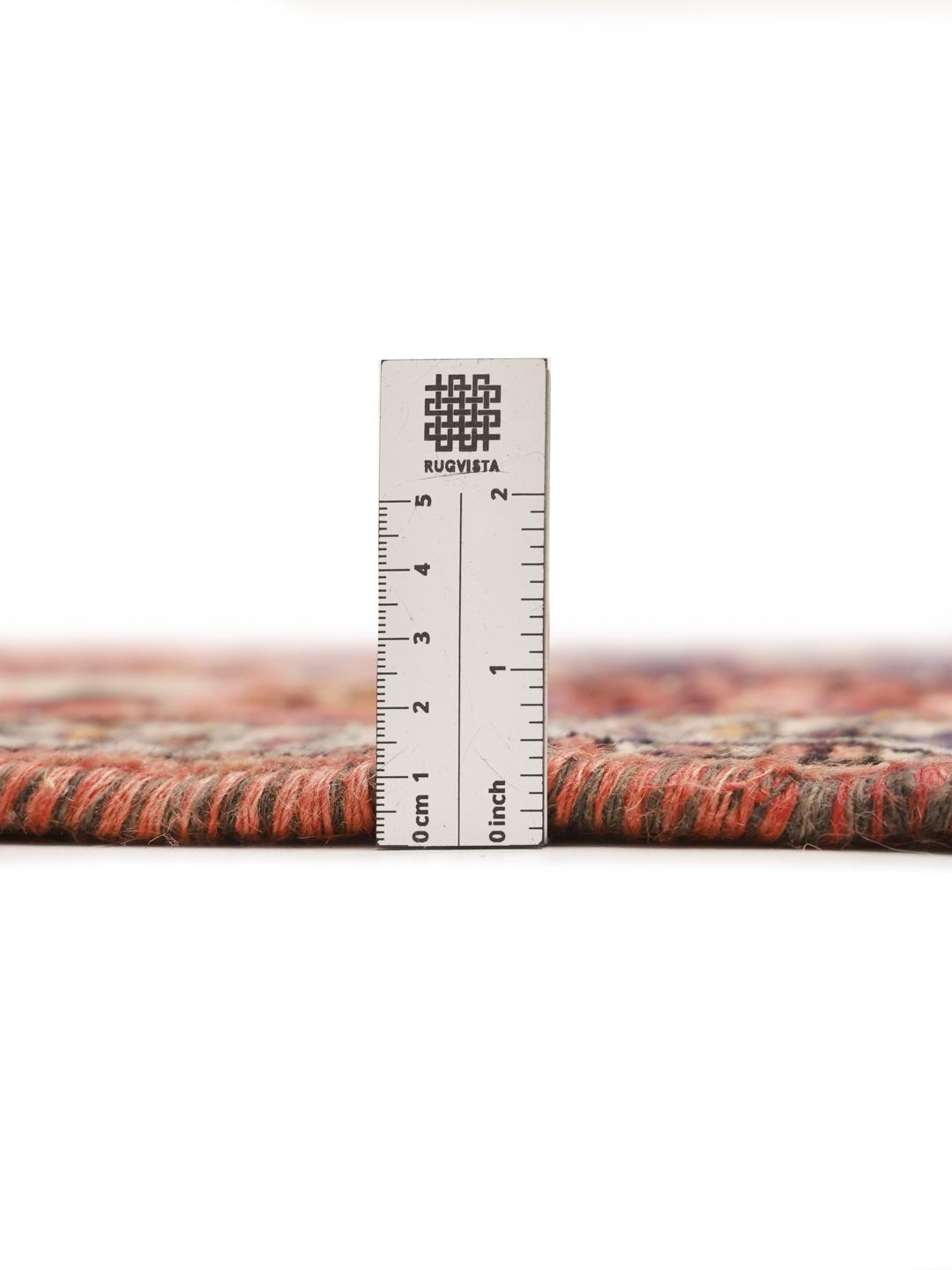 A hand-knotted Shiraz rug from the Middle East featuring a red field with geometric medallions.