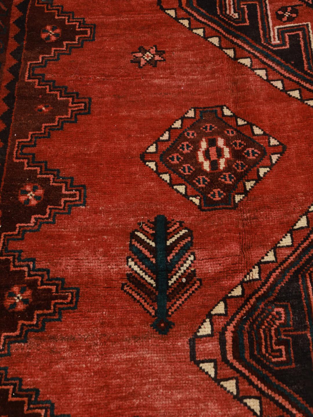 Hand-knotted Shiraz rug from the Middle East in vibrant red with geometric patterns