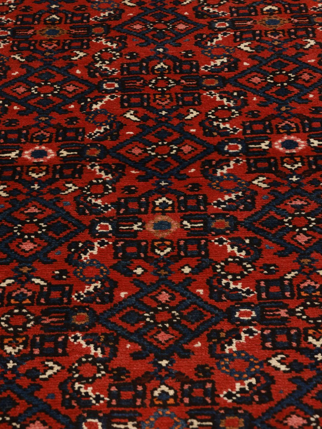 Hand-knotted Hosseinabad runner with traditional Middle Eastern motifs in red and dark blue
