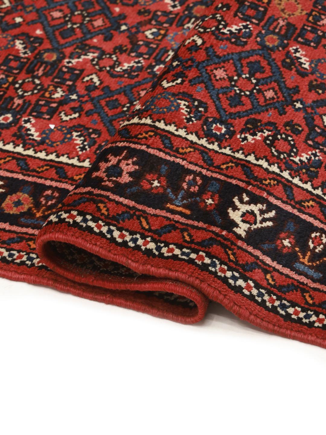 Hand-knotted Hosseinabad runner with traditional Middle Eastern motifs in red and dark blue