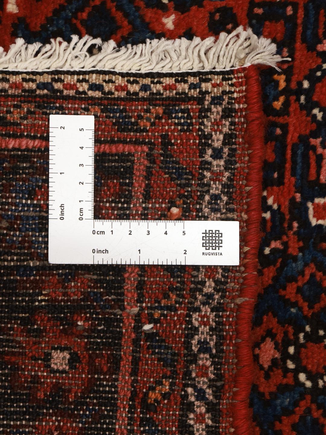 Hand-knotted Hosseinabad runner with traditional Middle Eastern motifs in red and dark blue