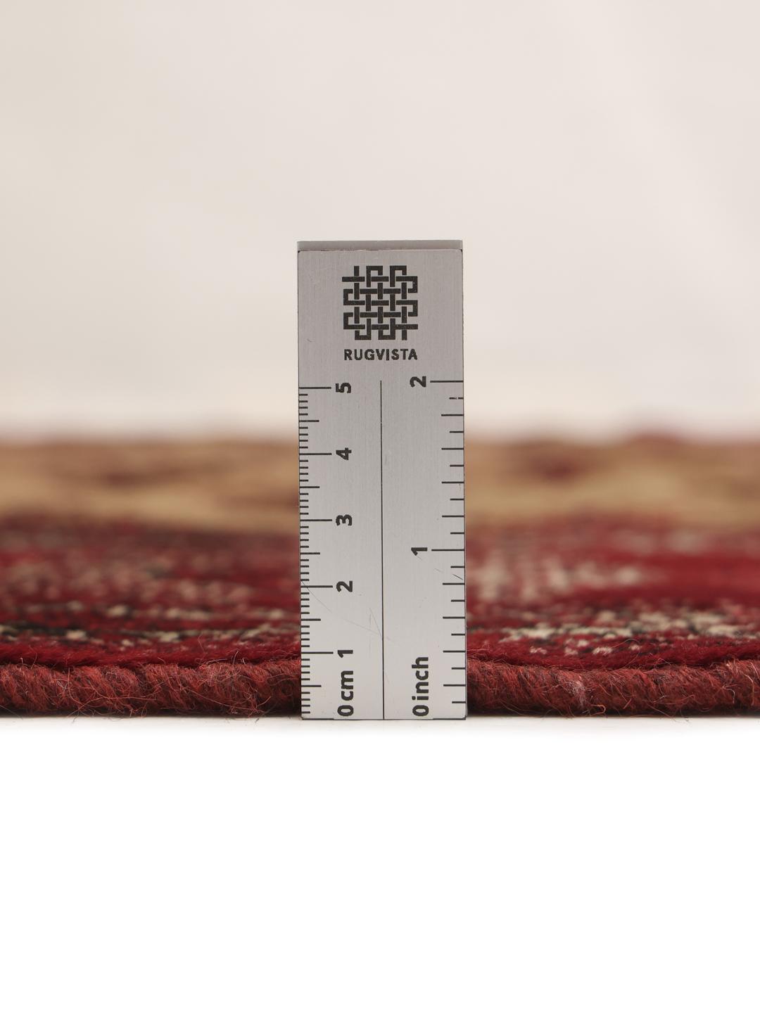 Hand-knotted Turkaman rug from the Middle East in deep red and beige tones.