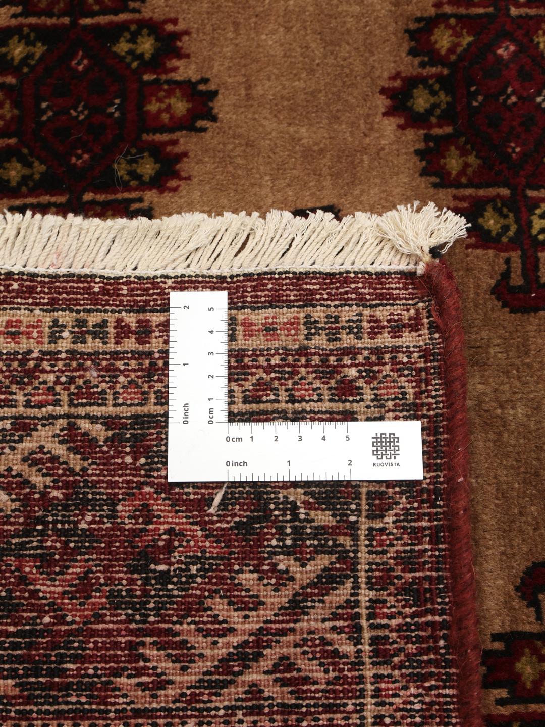 Hand-knotted Turkaman rug from the Middle East in deep red and beige tones.