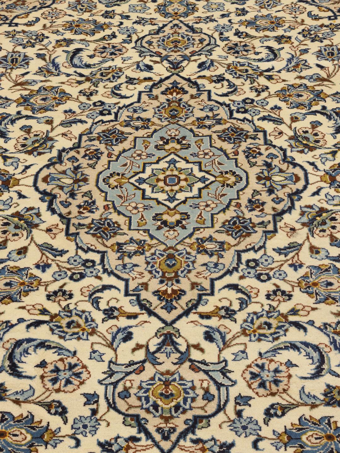 Hand-knotted Keshan rug from the Middle East with a floral pattern in blue and beige.