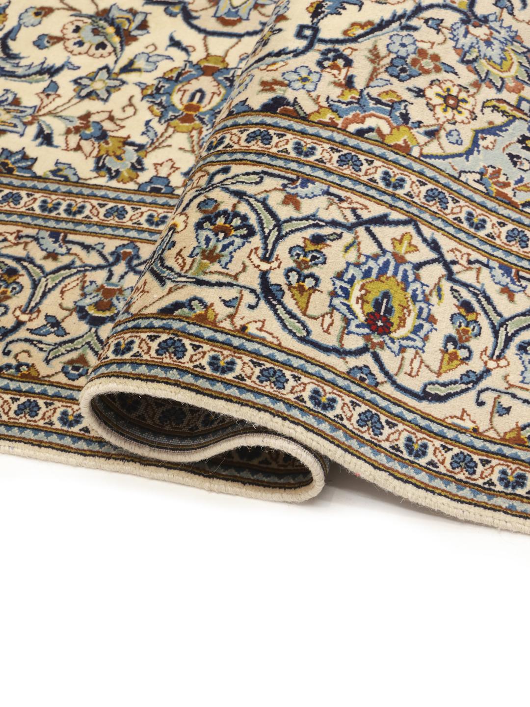 Hand-knotted Keshan rug from the Middle East with a floral pattern in blue and beige.