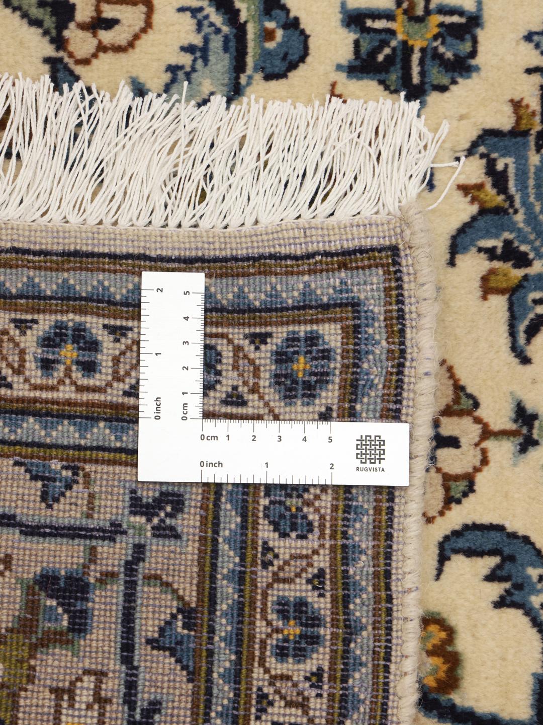 Hand-knotted Keshan rug from the Middle East with a floral pattern in blue and beige.