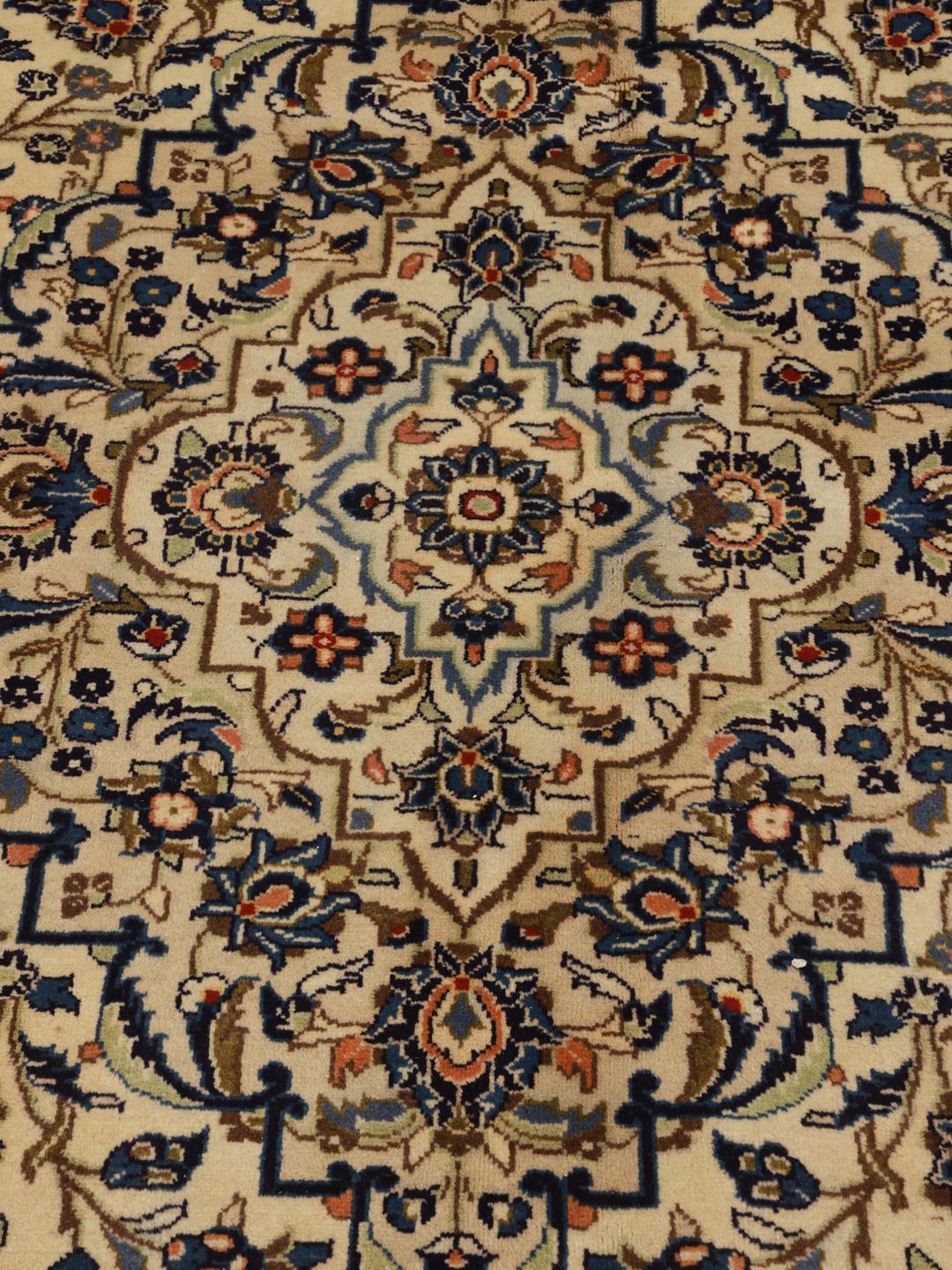 Hand-knotted Keshan rug from the Middle East in beige, blue, and orange tones.
