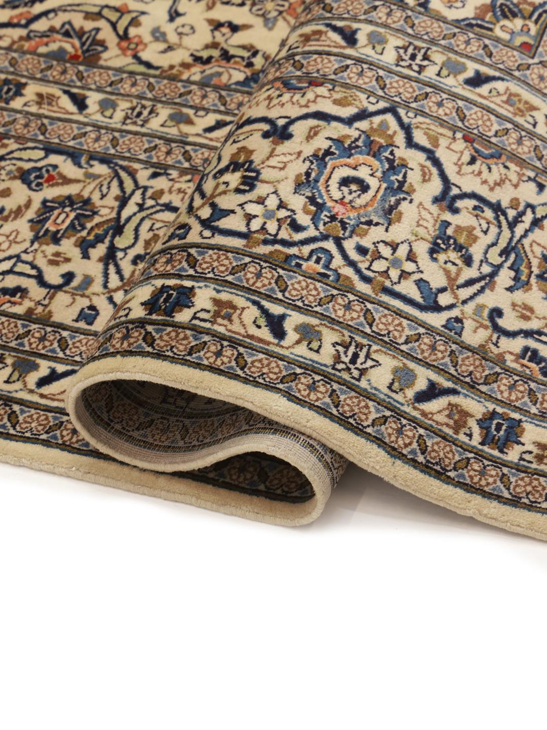 Hand-knotted Keshan rug from the Middle East in beige, blue, and orange tones.