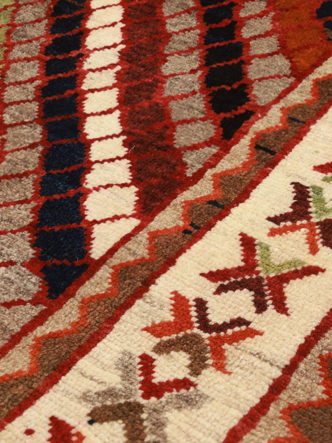 Hand-knotted Ghashghai rug from the Middle East with a multicolored diagonal lattice pattern