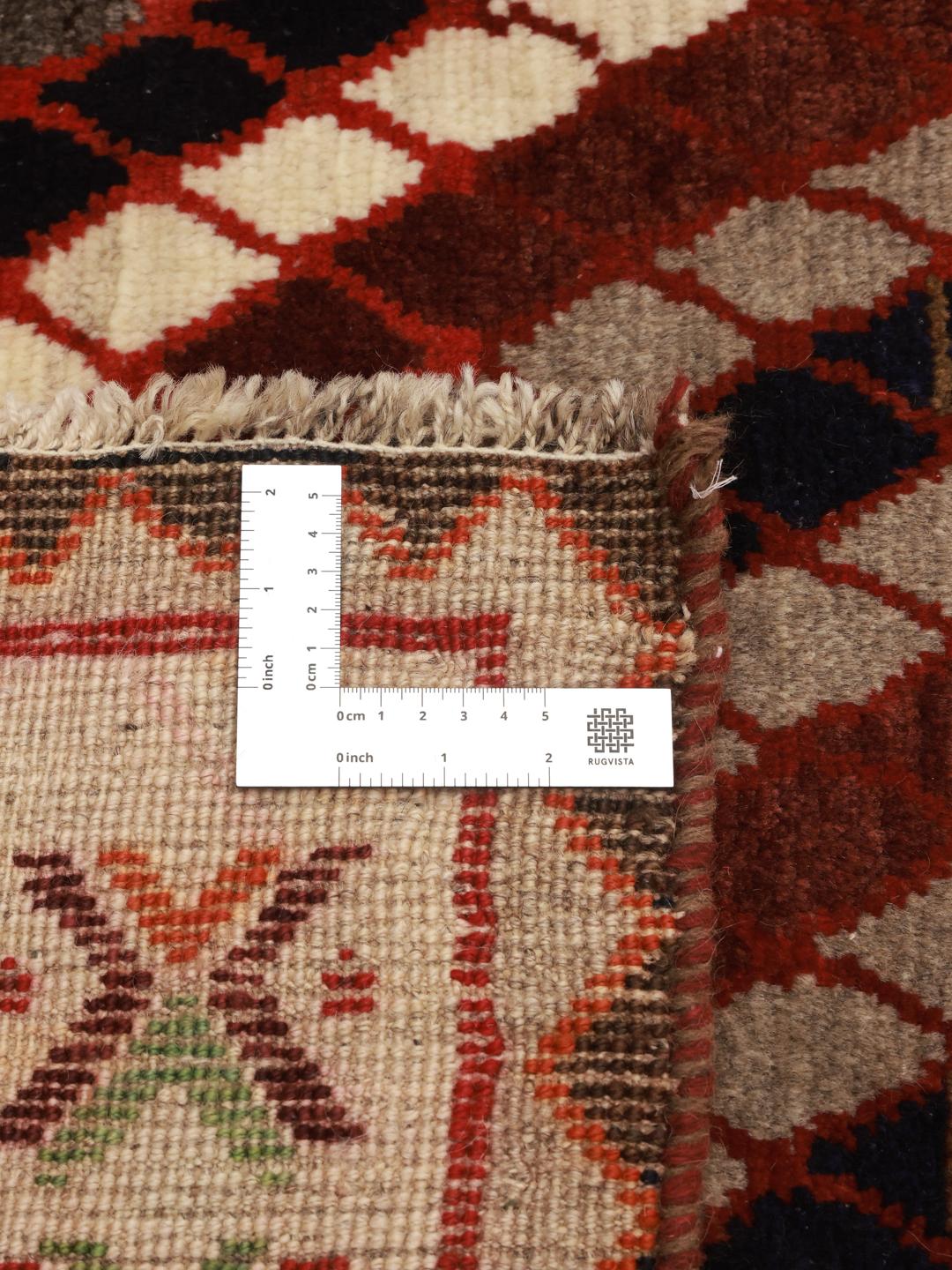 Hand-knotted Ghashghai rug from the Middle East with a multicolored diagonal lattice pattern