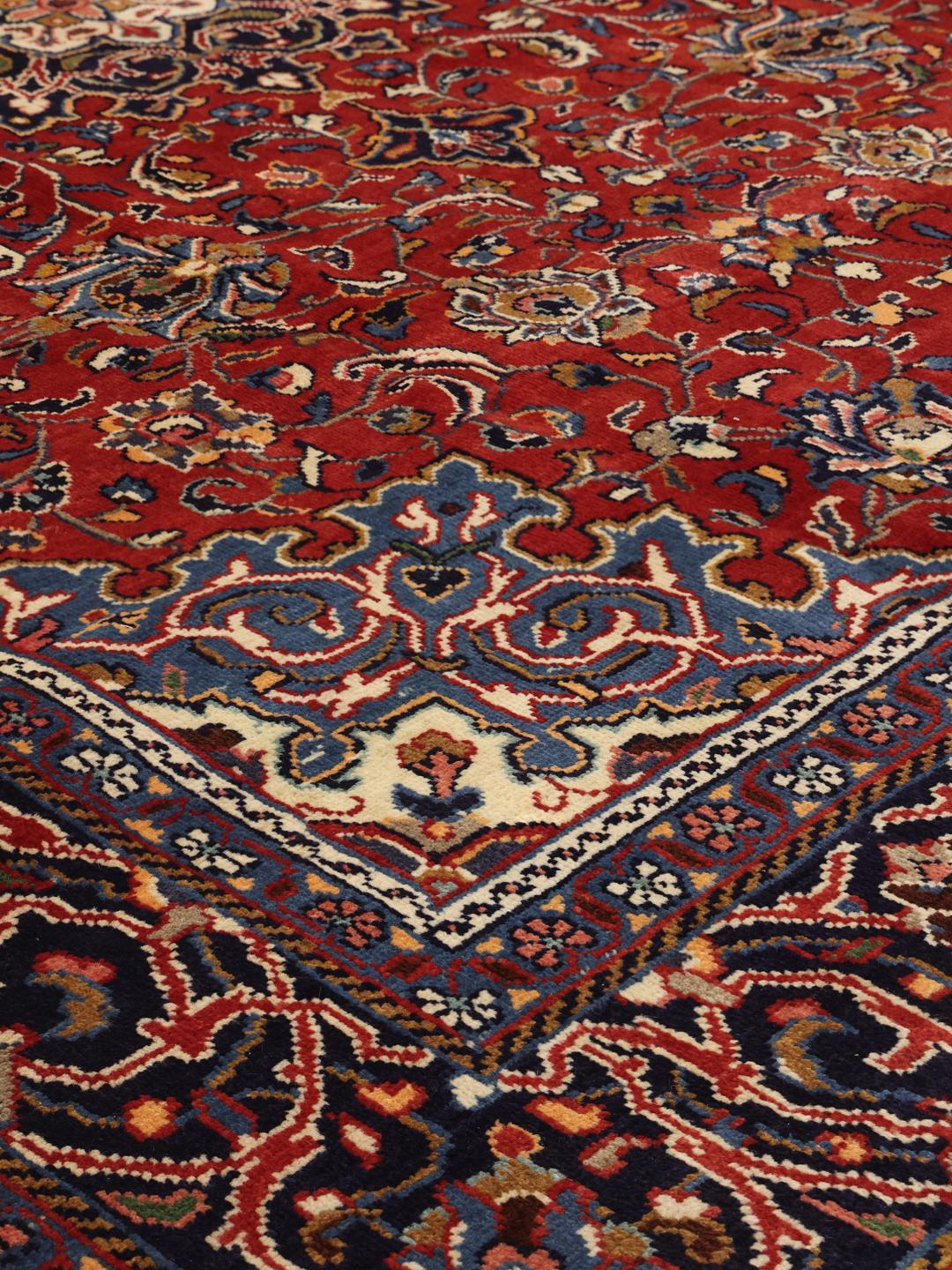 Hand-knotted Middle Eastern Sarough rug with a deep red field and floral patterns