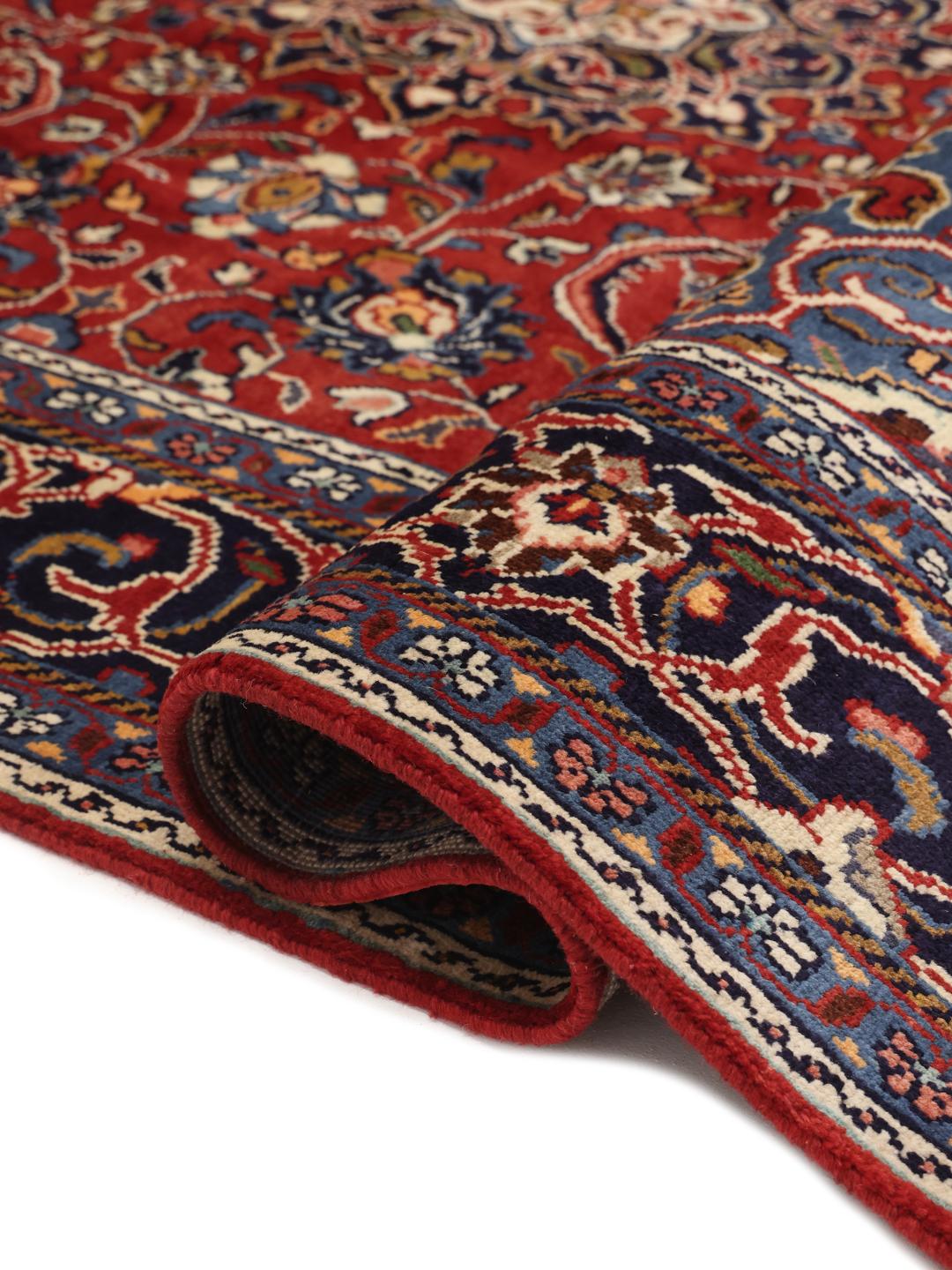 Hand-knotted Middle Eastern Sarough rug with a deep red field and floral patterns