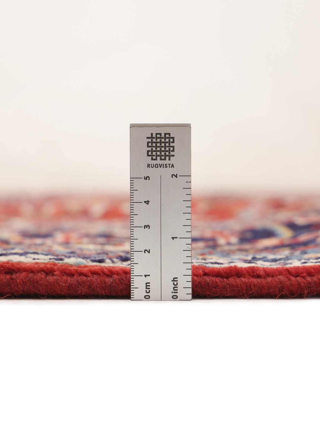 Hand-knotted Middle Eastern Sarough rug with a deep red field and floral patterns