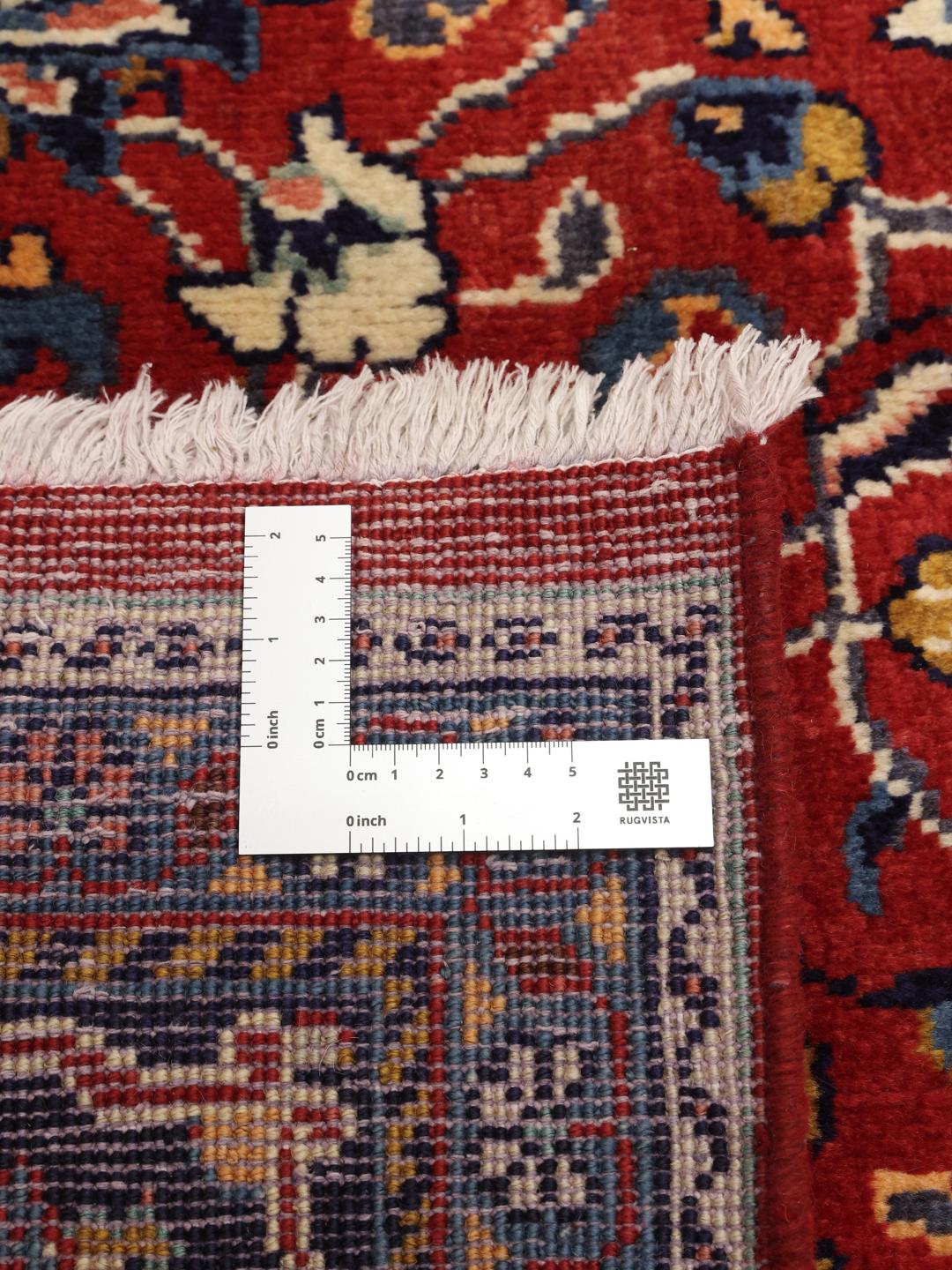 Hand-knotted Middle Eastern Sarough rug with a deep red field and floral patterns