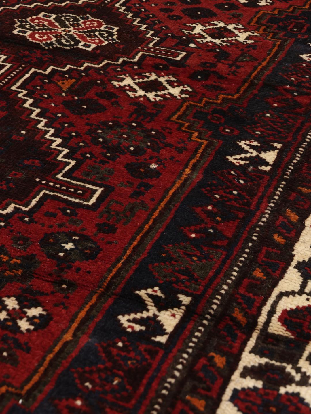 Hand-knotted Shiraz rug in dark red and black with tribal geometric patterns